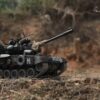 Iron Vanguard Alloy RC Tank showcasing turret rotation and rugged terrain capability