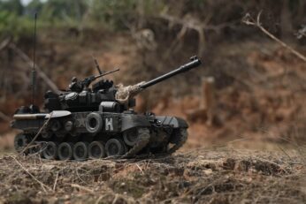 Iron Vanguard Alloy RC Tank showcasing turret rotation and rugged terrain capability