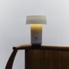 Fu Lamp glowing in a minimalist home setting, showcasing handcrafted porcelain base
