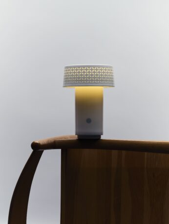 Fu Lamp glowing in a minimalist home setting, showcasing handcrafted porcelain base
