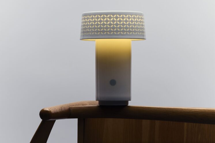 Fu Lamp glowing in a minimalist home setting, showcasing handcrafted porcelain base